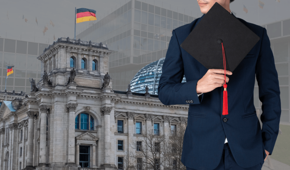 International student graduate in Germany holding a graduation cap with the German Parliament in Berlin, representing MBA and university education in Germany.