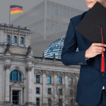 International student graduate in Germany holding a graduation cap with the German Parliament in Berlin, representing MBA and university education in Germany.