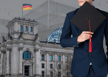 International student graduate in Germany holding a graduation cap with the German Parliament in Berlin, representing MBA and university education in Germany.